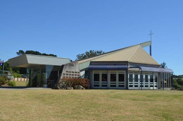 A building with a large lawn Description automatically generated with medium confidence